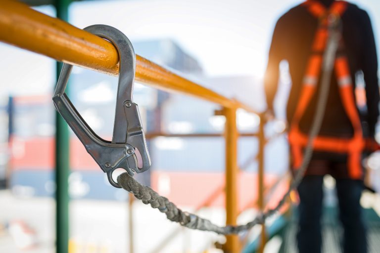 Construction worker with a safety harness on thinking about his safety net of savings