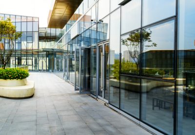 Modern glass office exterior which houses companies dealing with the property market